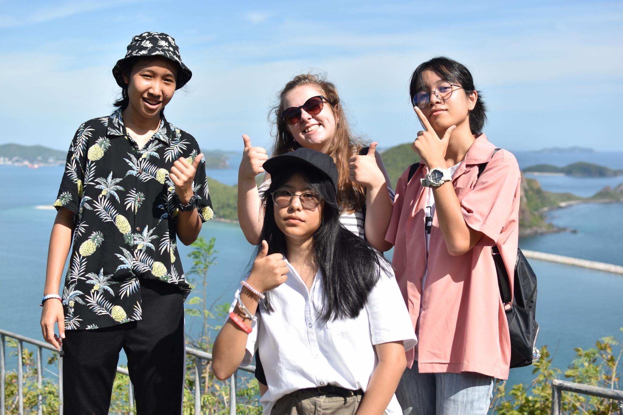 Lucy and her Thai friends standing on a hill overlooking the Thai coast